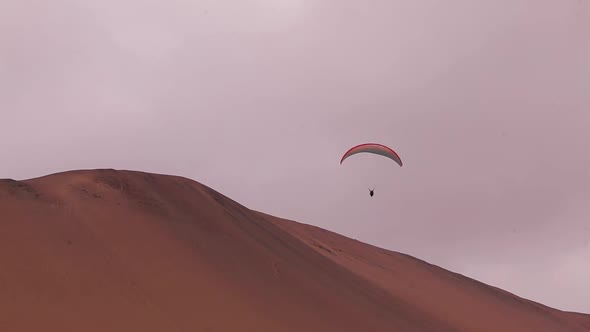 Parachute Parasailing in Peruvian Dunes Paracas National Reserve Twisting