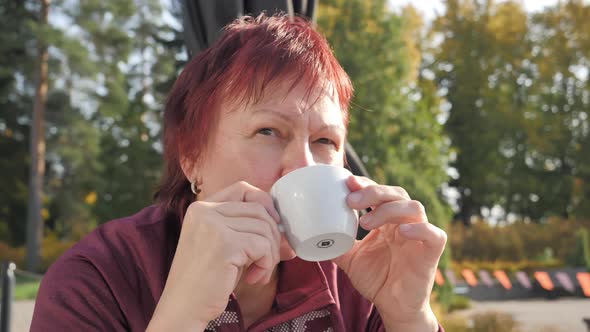 The Look of the Middleaged Lady Sipping Her Coffee alt