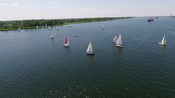 Aerial Shot of One-mast Sailboats Floating in the Dnipro River on a Sunny Day  