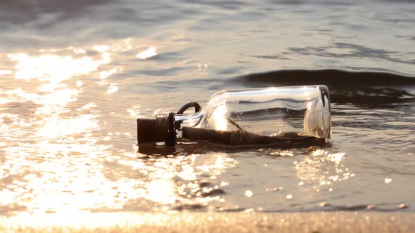 Message in the Bottle Against the Sun Setting Down alt