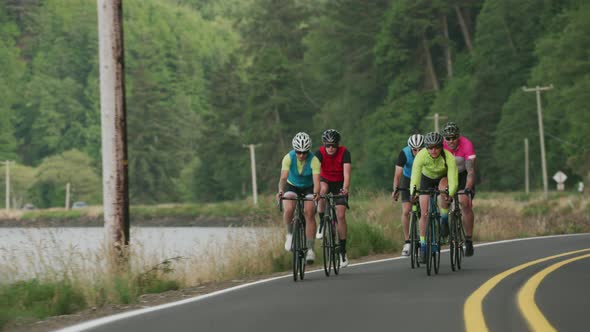 Tracking shot of a group of cyclists on country road.  Fully released for commercial use.