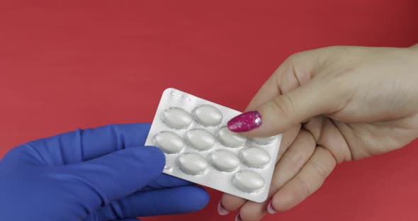 Doctor Hand in Medical Glove Gives Blister with Pills and Receive Cash Payment alt