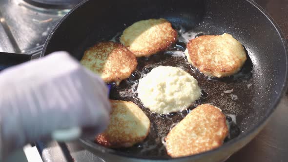 Preparation of golden crispy potato pancakes in a frying pan. Vegetable fritters. alt
