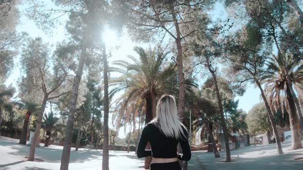 Walking Girl Between Palms alt