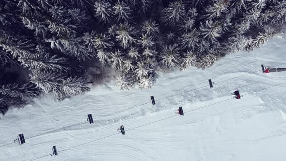 Aerial view of ski resort with people skiing down the hill and up lift