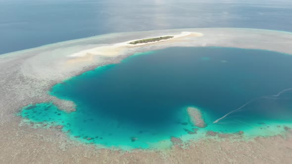 Aerial: Flying over idyllic atoll, Wakatobi Marine National Park Indonesia alt