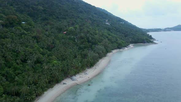 Aerial Descending Over Koh Phangan Empty Beach From High Altitude with Only Two People Swinging on alt