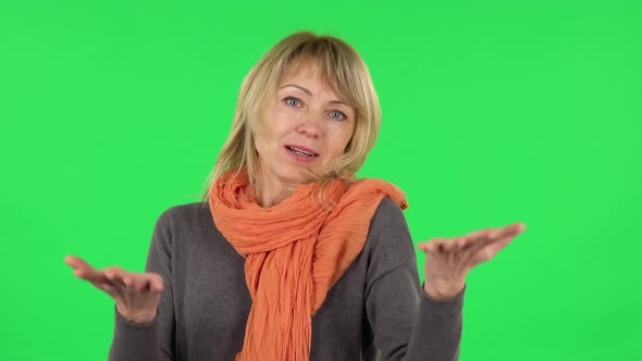 Portrait of Middle Aged Blonde Woman Is Indignantly Talking To Someone alt