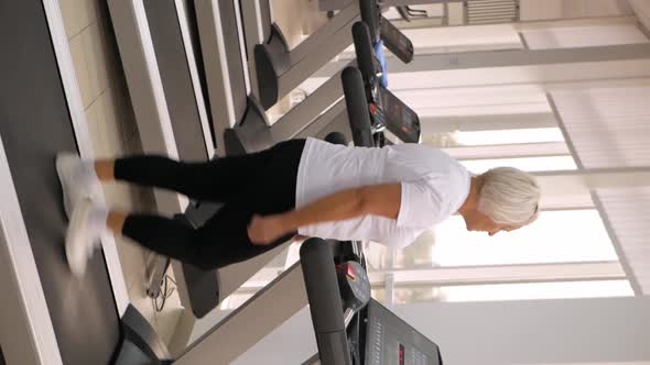 Elderly Woman Gray Hair Plays Sports in Gym