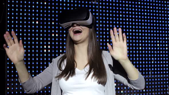 Beautiful Woman with Glasses Virtual Reality on a Shimmering Background alt