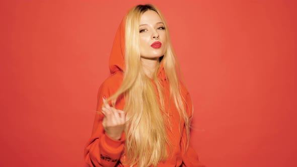 Portrait of young beautiful hipster bad girl in trendy red summer hoodie alt