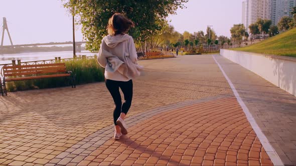 Back View Girl Running in the Early Morning alt