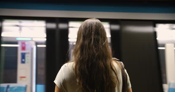 Woman with Mask Waiting for Train at Metro alt