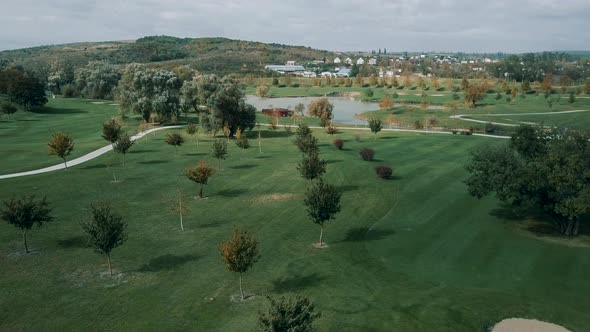 Beautiful panorama of a well-kept garden with a lawn and a small lake in the middle