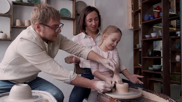 Craft Person Family Molding Pot in Small Workshop Studio