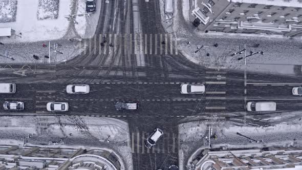 Top View of Snow City Street with Road Traffic