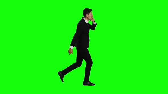Businessman Is a Telephone Rings To Him and He Talks. Green Screen alt