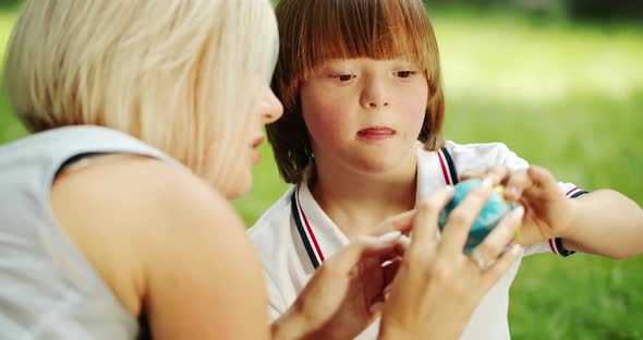 Down Syndrome Boy Playing with Mother