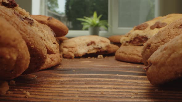 Macro Zoom in Video of Crispy Oat Cookies on Wooden Board in Kitchen