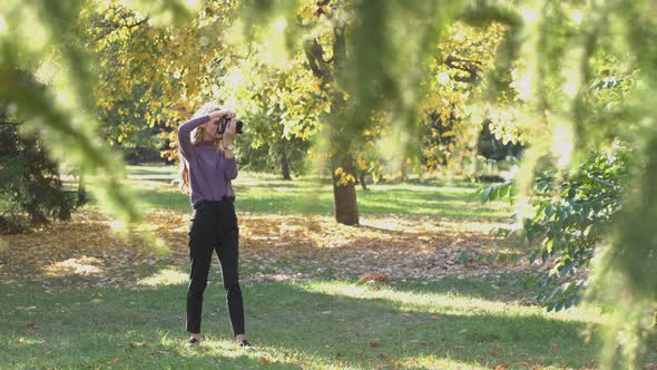 Girl with Camera in Park