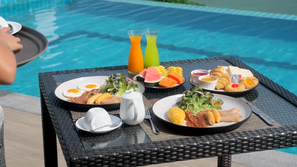 Female Waiter Hand Serving Breakfast Food in Restaurant at Luxury Hotel Resort alt