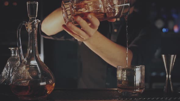 Bartender Prepares a Cocktail at the Bar