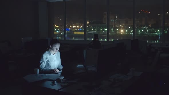 Tired Woman Working in Office at Night alt