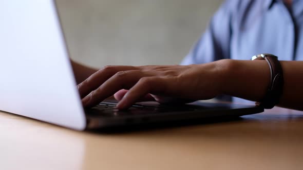 Closeup a woman working and typing on laptop computer keyboard on the table