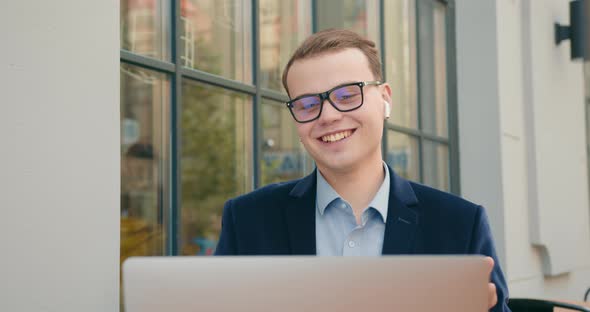 A Businessman is Conducting a Video Meeting Via a Laptop alt