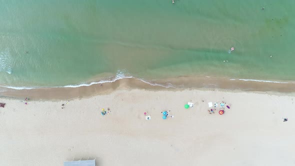 People Keep Social Distance on Beach. There Are Few Tourists on the Seaside Due To the Coronavirus alt