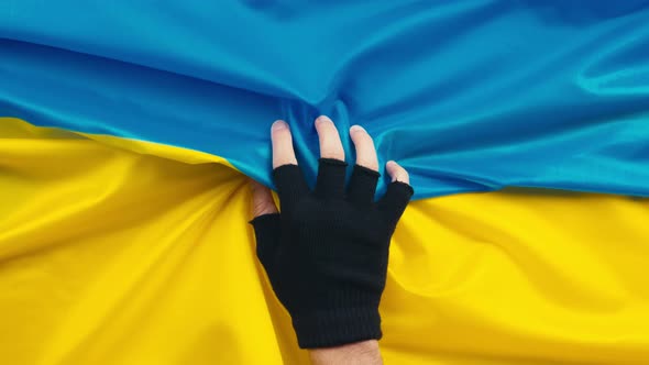 Hand Holds Flag of Ukraine alt