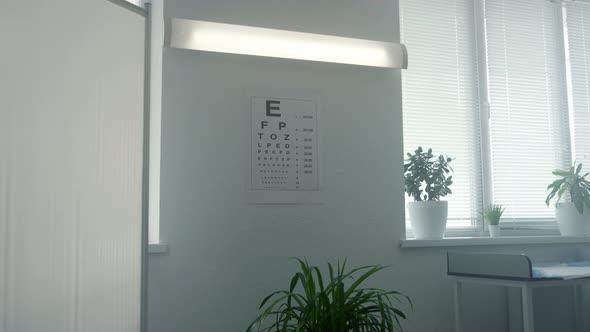 Standard Eyesight Test Chart Hanging White Wall in Doctor Office Close Up alt