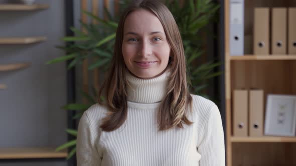 Indoor Portrait of Beautiful Brunette Young Woman Smiling Cheerfully, Feeling Happy and Carefree  alt