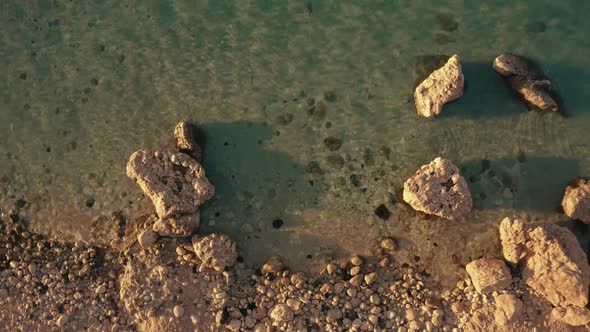 View of Rocky Beach with Transparent Clear Sea Water Close Up alt
