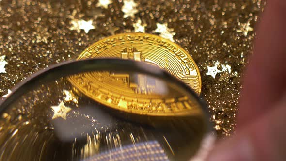 Closeup View Through Loupe on Bitcoin Model Against Light Rays alt