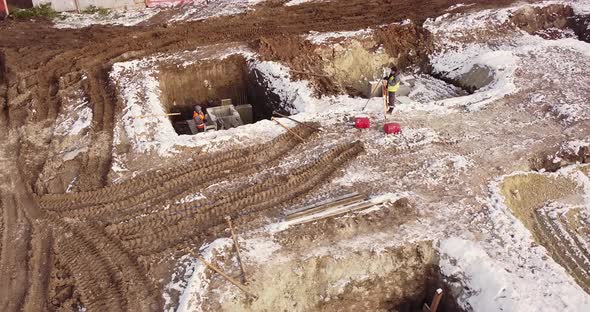 Construction Worker Using Theodolite Surveying Optical Instrument for Measuring alt