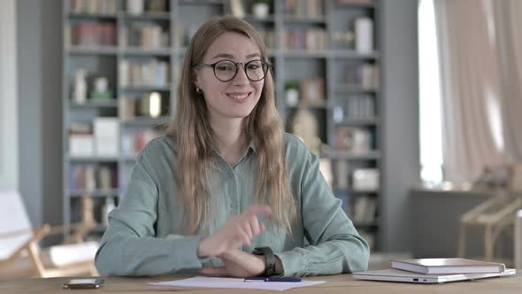 Cheerful Young Woman Pointing Finger at Camera and Inviting alt