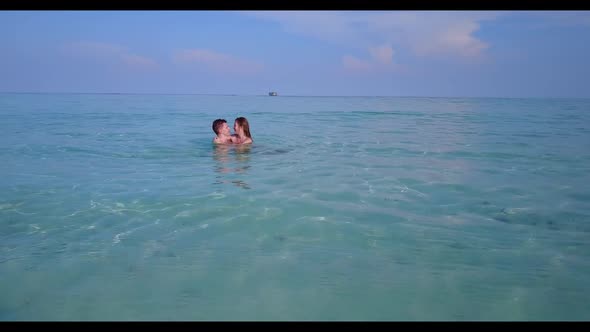 Two people suntan on idyllic sea view beach voyage by blue sea with white sand background of the Mal alt