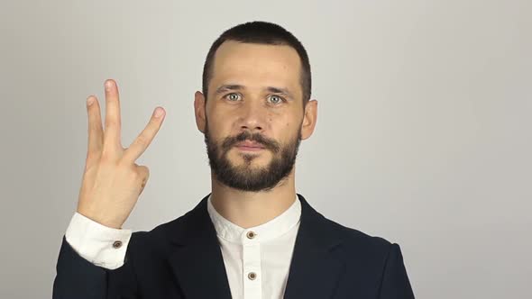 Young Handsome Businessman Shows Three Fingers While Counting