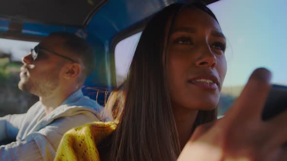 Young couple on a road trip in their pick-up truck alt