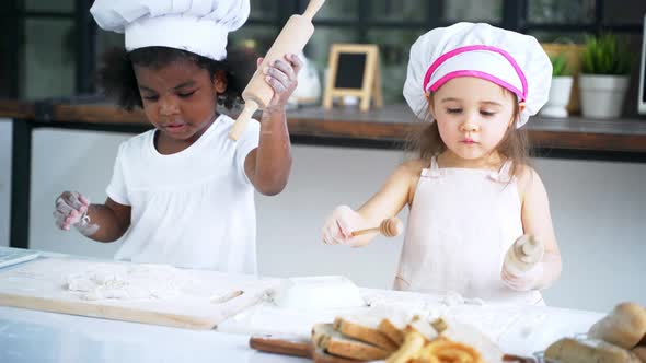 Diverse Group of Girls Prepare the Dough and Bake Cookies in the Kitchen alt