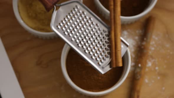 Grinding cinnamon stick in kitchen alt