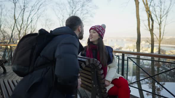 Happy Romantic Couple Haveing a Date on the Bench at Sunny Winter Day alt