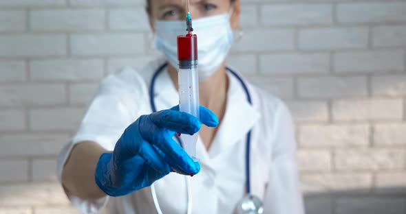 Doctor with fresh blood.  alt