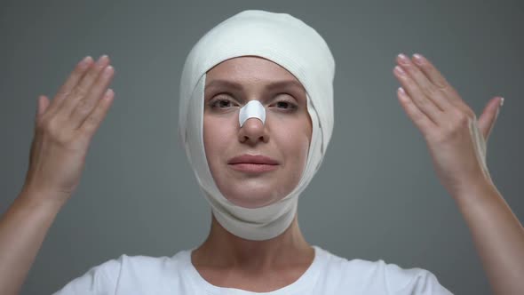 Lady in Headwrap Looking at Her Reflection After Plastic Surgery, Lifting