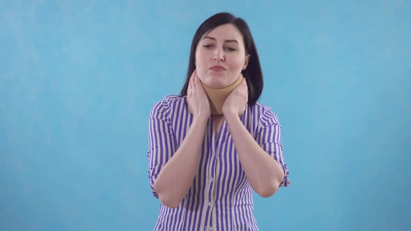 Young Woman in Protective Collar Against Neck Pain Standing on Blue Background alt