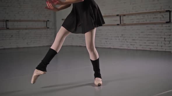 Closeup of Ballerina Feet in Pointe Shoes and Black Dress Dancing Ballet Elements Slow Motion