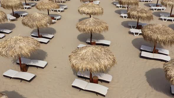 Aerial view of beach umbrellas and sunbeds on sand beach