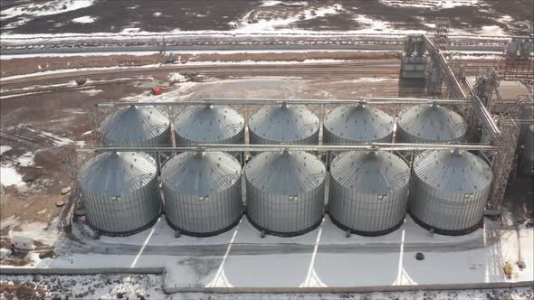 Aerial View of Drone on a Large Granary in a Field on a Background of a Sunset alt