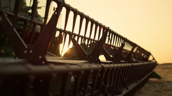 Combine Thresher Standing Field Thatch Summer at Golden Sunset Closeup alt